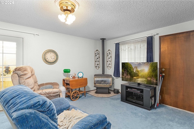 carpeted living room with a textured ceiling and a wood stove