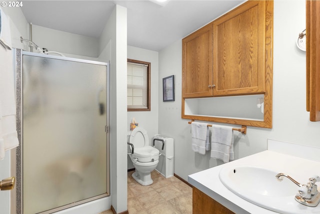 bathroom featuring vanity, toilet, and a shower with shower door