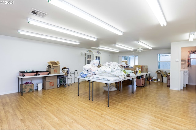 game room with ceiling fan and light wood-type flooring