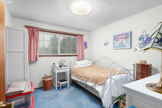 carpeted bedroom with a textured ceiling