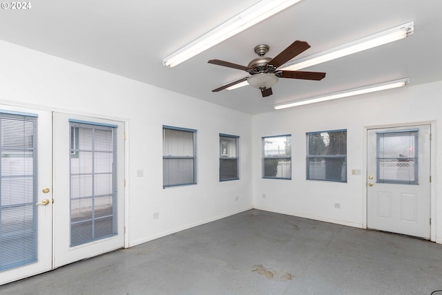 unfurnished sunroom featuring ceiling fan