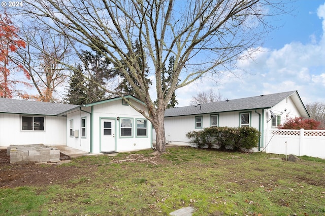 rear view of property with a yard