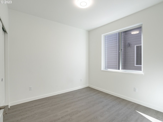 empty room featuring baseboards and wood finished floors