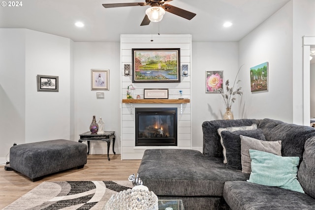 living room featuring ceiling fan and light wood-type flooring