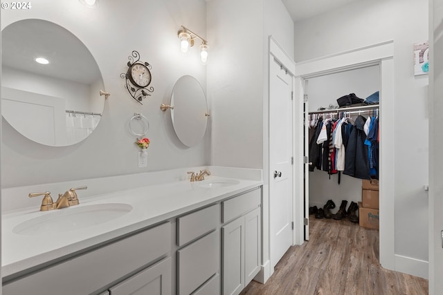 bathroom featuring double vanity and hardwood / wood-style flooring