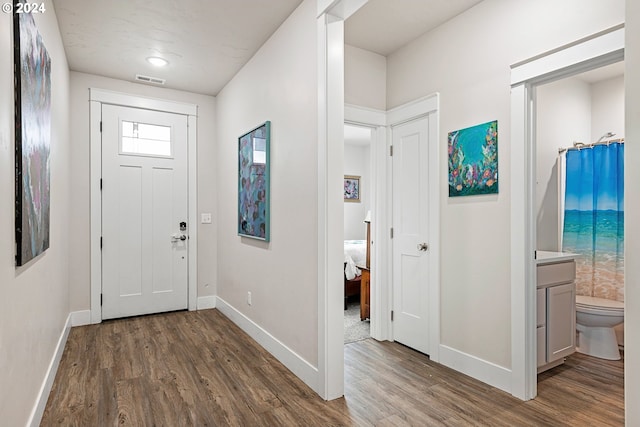 entryway with dark wood-type flooring