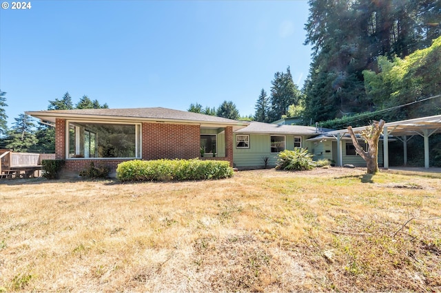 ranch-style home with a front lawn