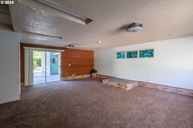 unfurnished room featuring a textured ceiling and carpet flooring