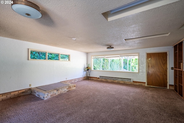 carpeted empty room with a textured ceiling and a baseboard radiator