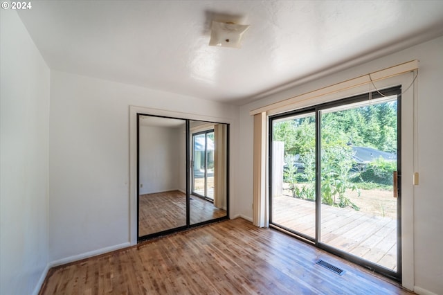 unfurnished room with wood-type flooring