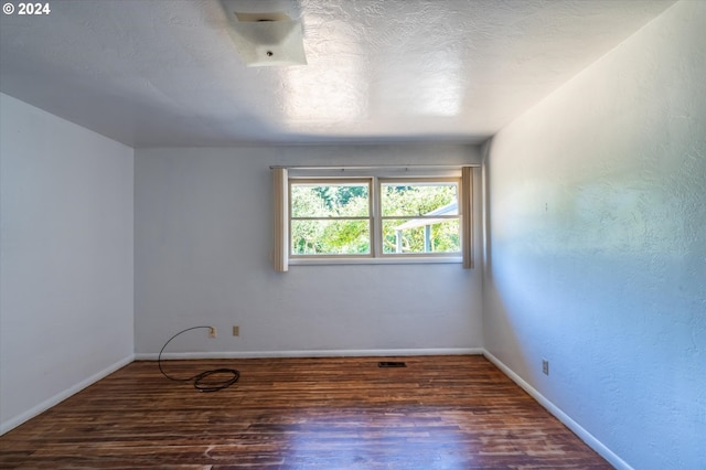 empty room with dark hardwood / wood-style floors