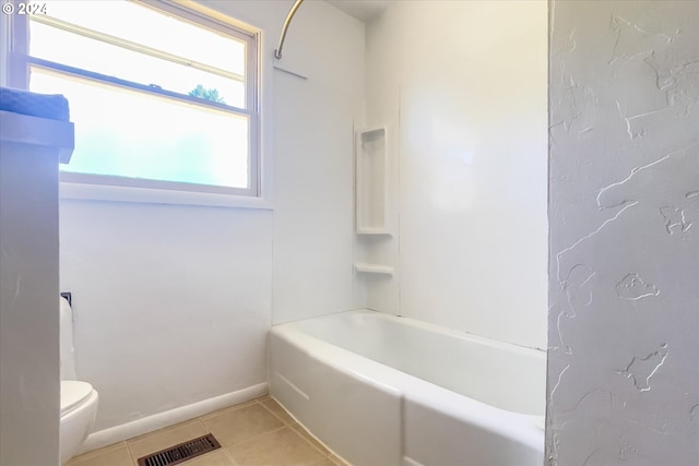 bathroom with tub / shower combination, tile patterned flooring, and toilet