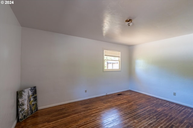 unfurnished room featuring dark hardwood / wood-style flooring