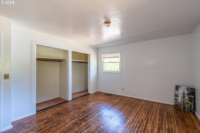 unfurnished bedroom featuring dark wood-type flooring