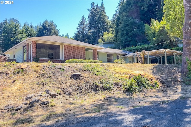 ranch-style house featuring a carport