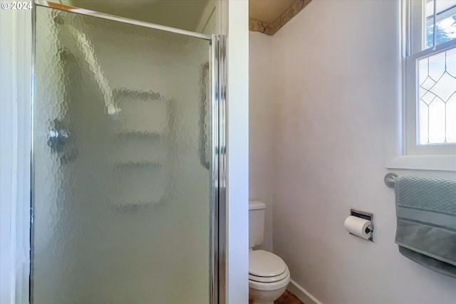 bathroom featuring walk in shower and toilet