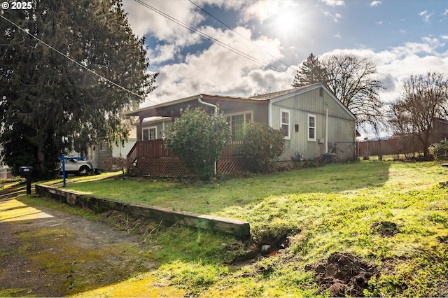 view of side of property with a lawn