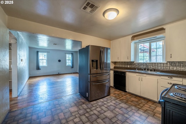 680 NE Laurance St, Myrtle Creek, OR 97457 - kitchen with black appliances, dark countertops, backsplash, and white cabinetry