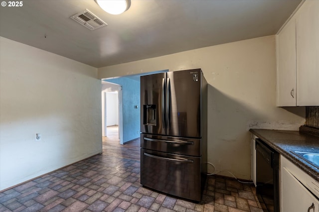 680 NE Laurance St, Myrtle Creek, OR 97457 - kitchen featuring stainless steel fridge with ice dispenser, black dishwasher, brick patterned flooring, white cabinetry, and dark countertops