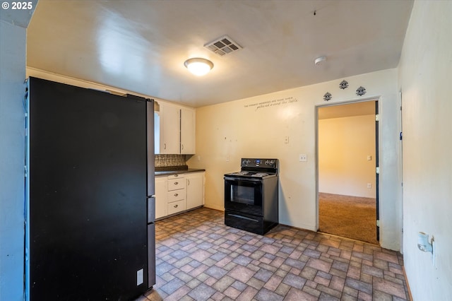 680 NE Laurance St, Myrtle Creek, OR 97457 - kitchen featuring black electric range, freestanding refrigerator, dark countertops, and brick patterned flooring