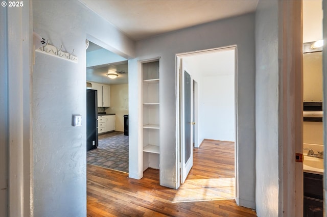 hallway with hardwood / wood-style floors