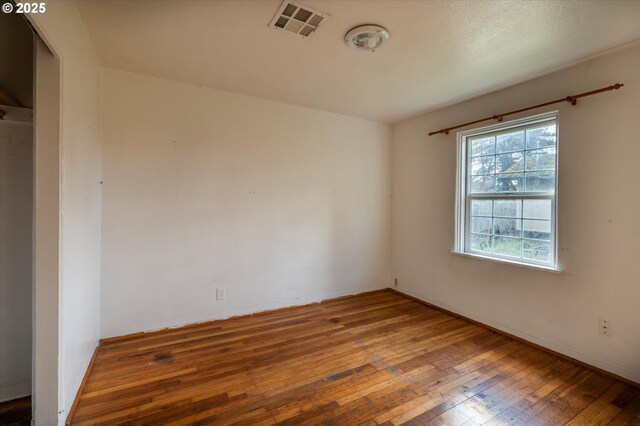 spare room with hardwood / wood-style flooring