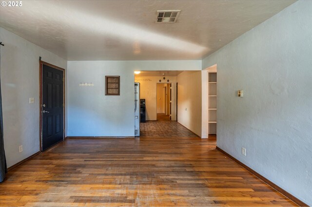 unfurnished room featuring dark hardwood / wood-style flooring