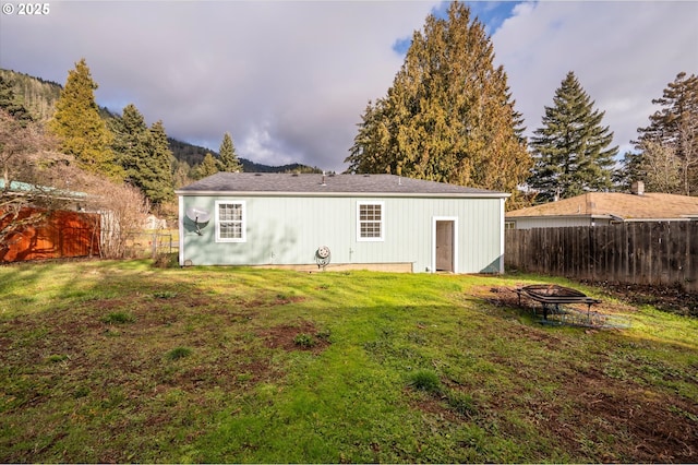 680 NE Laurance St, Myrtle Creek, OR 97457 - back of property with an outdoor fire pit and a fenced backyard