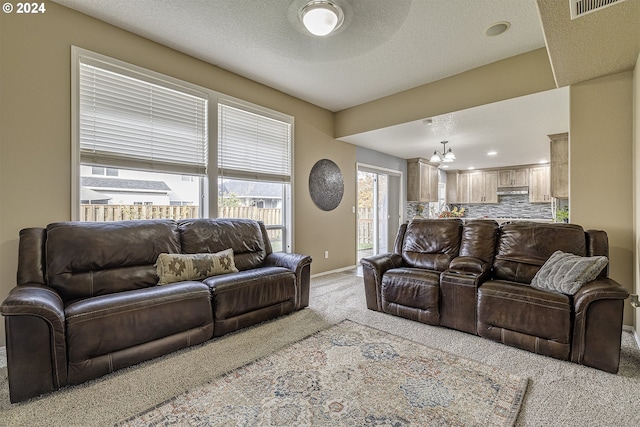 41637 NW Buckshire St, Banks, OR 97106 - living room featuring light colored carpet, a chandelier, baseboards, recessed lighting, and a textured ceiling