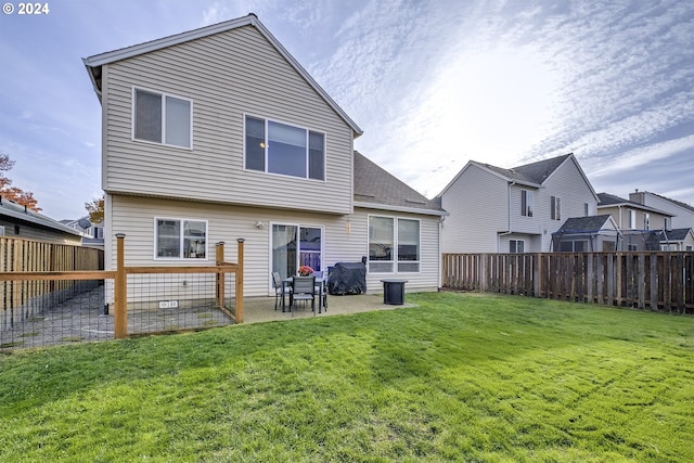 rear view of property with a patio and a yard