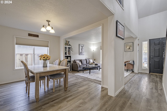 41637 NW Buckshire St, Banks, OR 97106 - dining space with a chandelier, wood finished floors, a textured ceiling, and baseboards