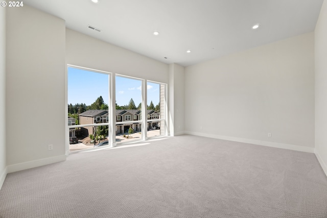 unfurnished room with carpet floors, recessed lighting, and baseboards