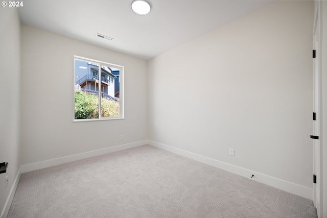 carpeted spare room with baseboards and visible vents