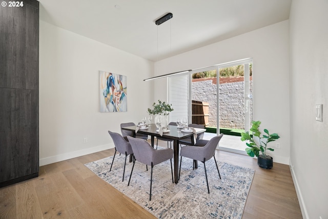 dining area featuring wood finished floors and baseboards