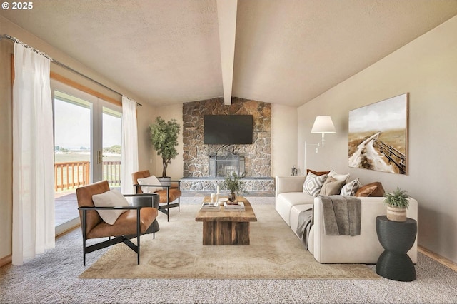 living room featuring vaulted ceiling with beams, a textured ceiling, light carpet, and a fireplace