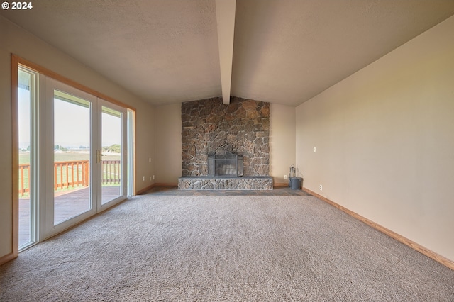 unfurnished living room with carpet floors, baseboards, lofted ceiling with beams, and a textured ceiling