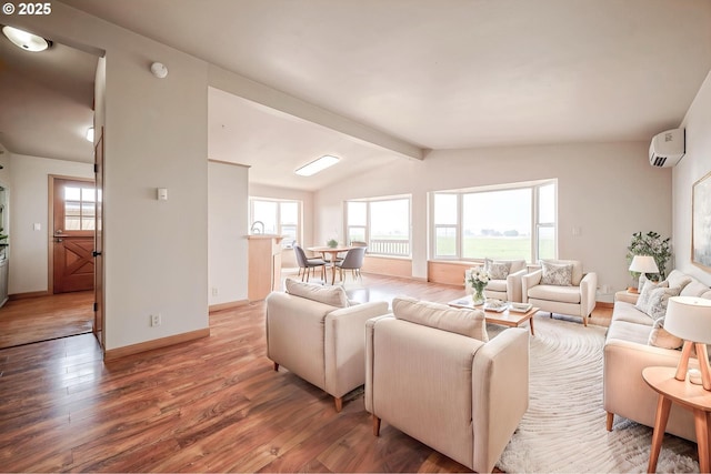 living area with vaulted ceiling with beams, a wall mounted AC, wood finished floors, and baseboards