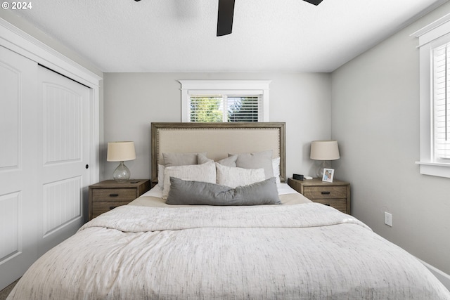 bedroom with a closet, a textured ceiling, and ceiling fan