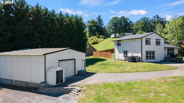 exterior space featuring a garage and a lawn