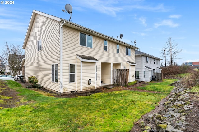 rear view of property featuring a yard