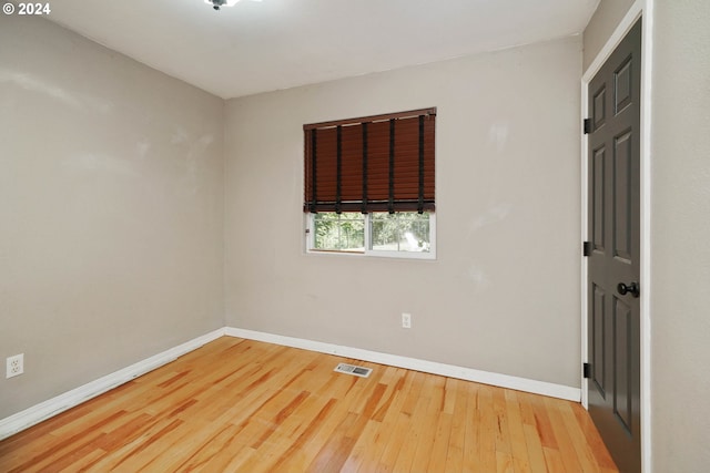 unfurnished room featuring wood-type flooring