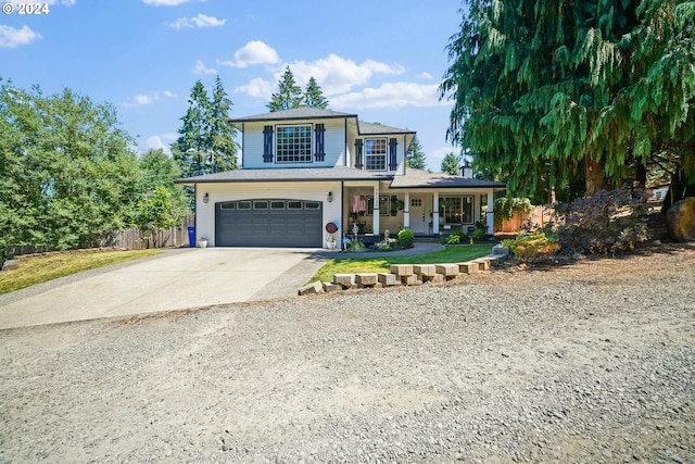 view of front of house featuring a porch and a garage