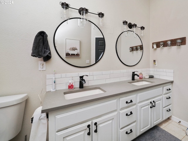 bathroom featuring tile patterned floors, vanity, toilet, and backsplash