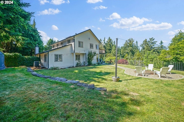 back of property with cooling unit and a lawn