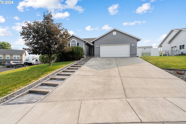 view of front of house with a garage and a front lawn