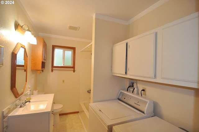 clothes washing area with crown molding, sink, and washer and clothes dryer