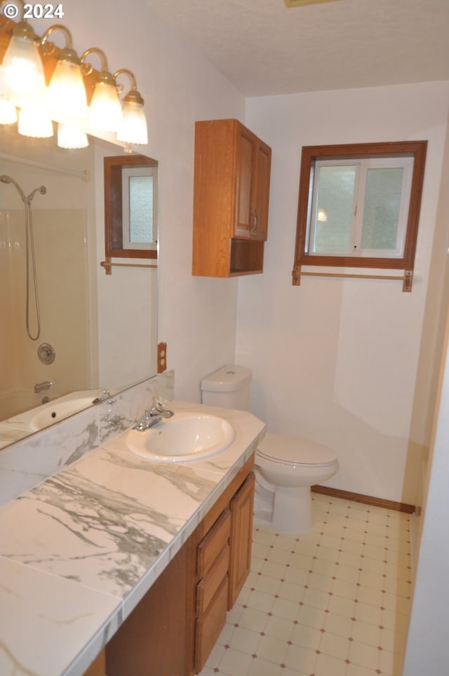 full bathroom featuring washtub / shower combination, vanity, and toilet