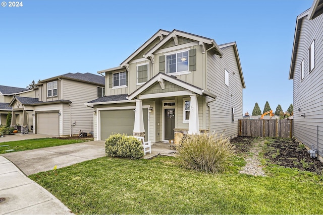 craftsman-style house with a front yard, fence, concrete driveway, a garage, and board and batten siding