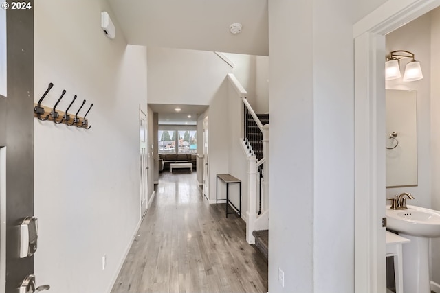 entrance foyer featuring baseboards, wood finished floors, and stairs