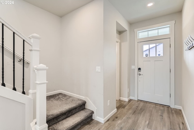 foyer featuring recessed lighting, baseboards, light wood-style flooring, and stairs